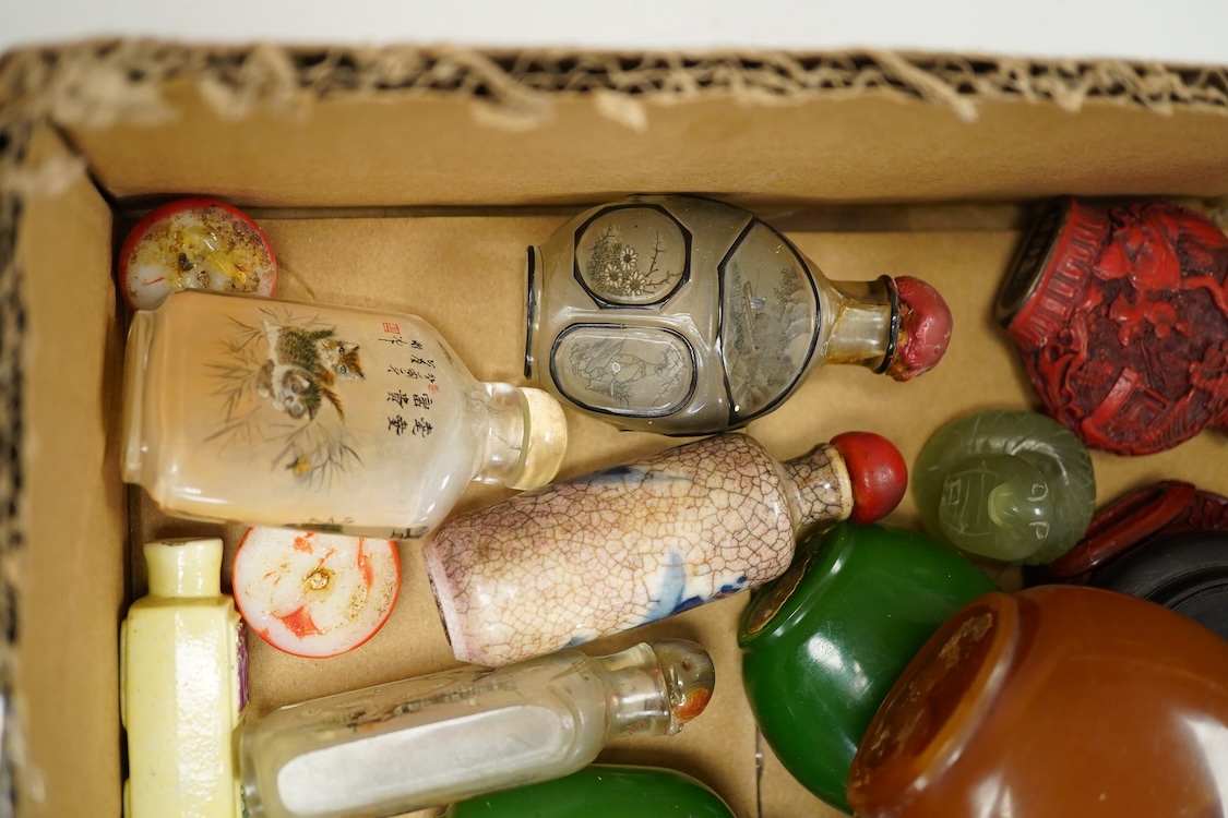 A small collection of Chinese snuff bottles, 19th century and later to include reverse glass painted examples and cinnabar lacquered examples, largest 9.5cm high